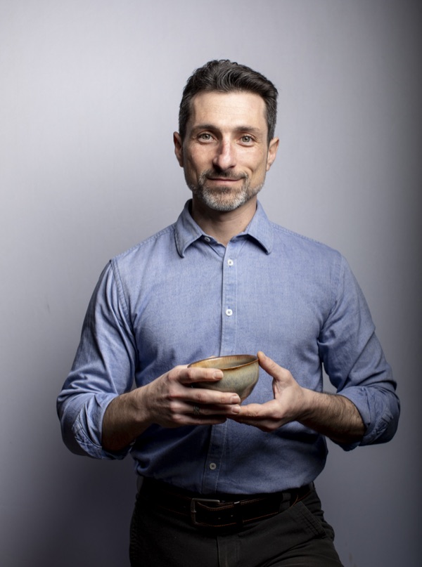 Henry Finkelstein holding a bowl of tea